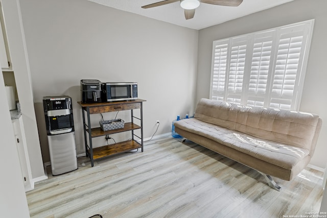 living area featuring ceiling fan and light hardwood / wood-style flooring