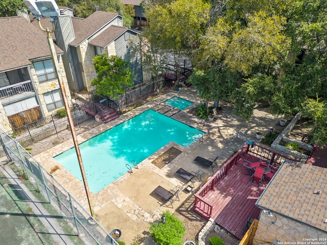 view of pool with a wooden deck and a patio area