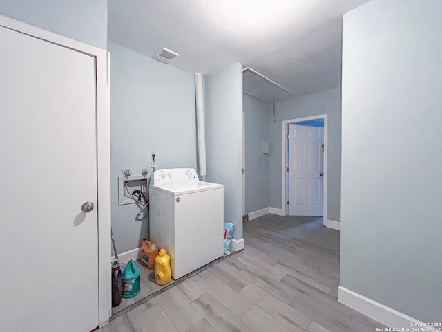 washroom featuring light wood-type flooring and washer / clothes dryer