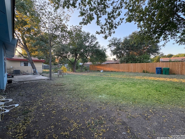 view of yard featuring central AC and a patio area