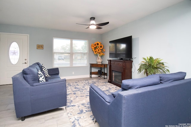 living room with light wood-type flooring and ceiling fan