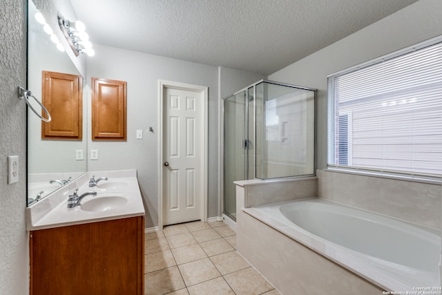 bathroom featuring shower with separate bathtub, tile patterned floors, a textured ceiling, and vanity