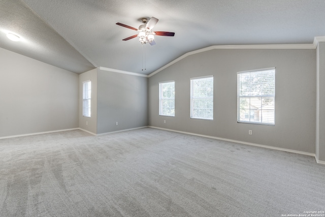 spare room featuring lofted ceiling, light carpet, ceiling fan, and plenty of natural light