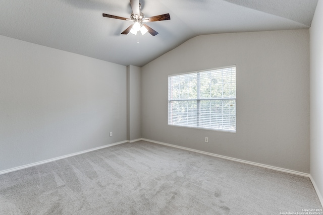 unfurnished room with ceiling fan, lofted ceiling, and carpet