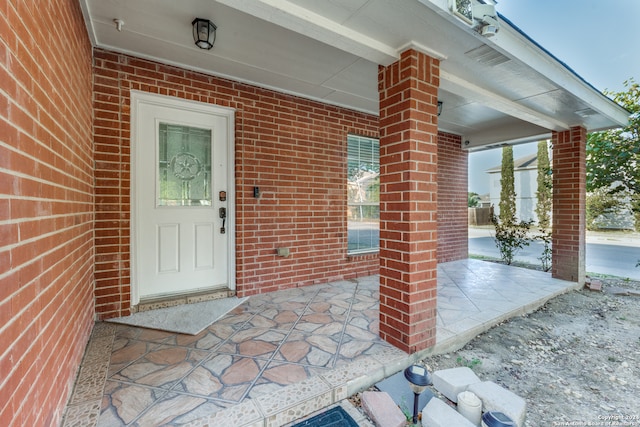 view of exterior entry featuring a patio