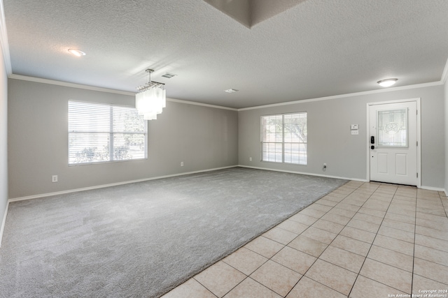 interior space featuring light carpet, a textured ceiling, crown molding, and a notable chandelier