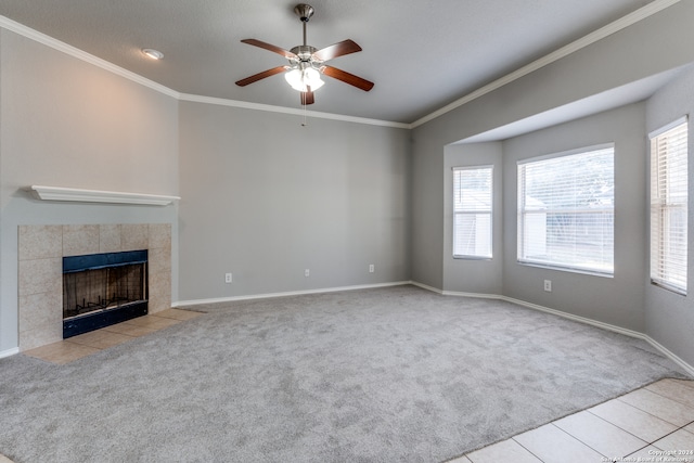 unfurnished living room featuring ornamental molding, light carpet, ceiling fan, and a fireplace