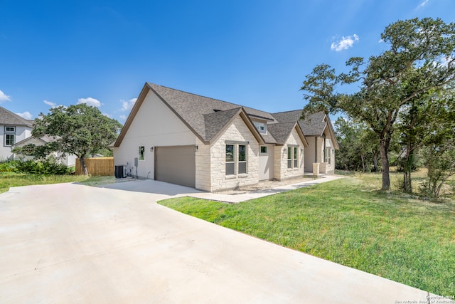 view of front facade featuring cooling unit, a front lawn, and a garage