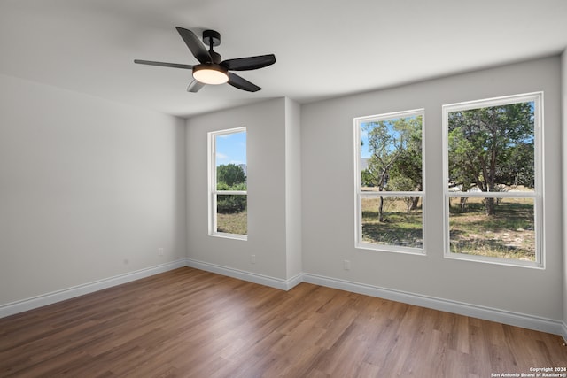 unfurnished room featuring ceiling fan and hardwood / wood-style floors