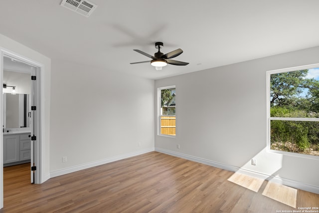 unfurnished room with light wood-type flooring and ceiling fan