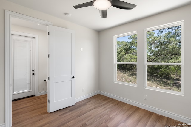 empty room with light hardwood / wood-style floors and ceiling fan