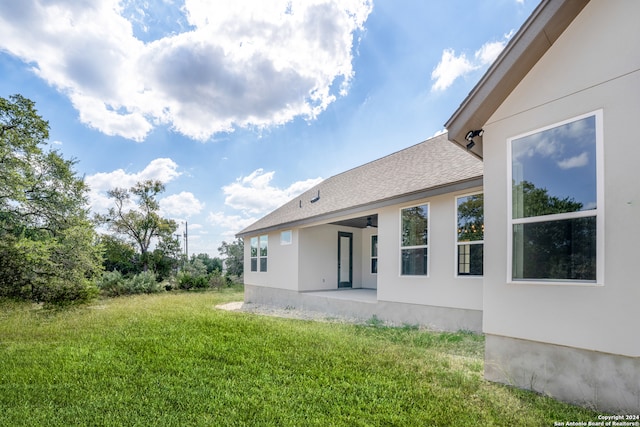 back of house featuring a yard and a patio area