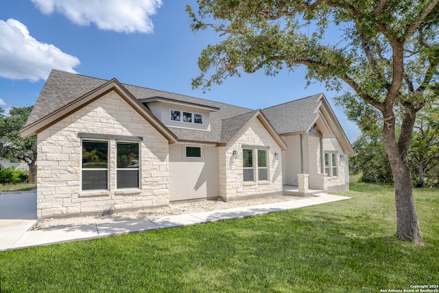 back of house with a lawn and a patio area