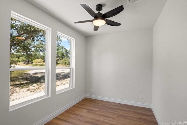 empty room featuring wood-type flooring and ceiling fan