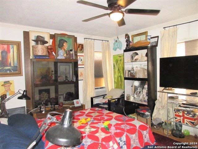 bedroom with ceiling fan and ornamental molding