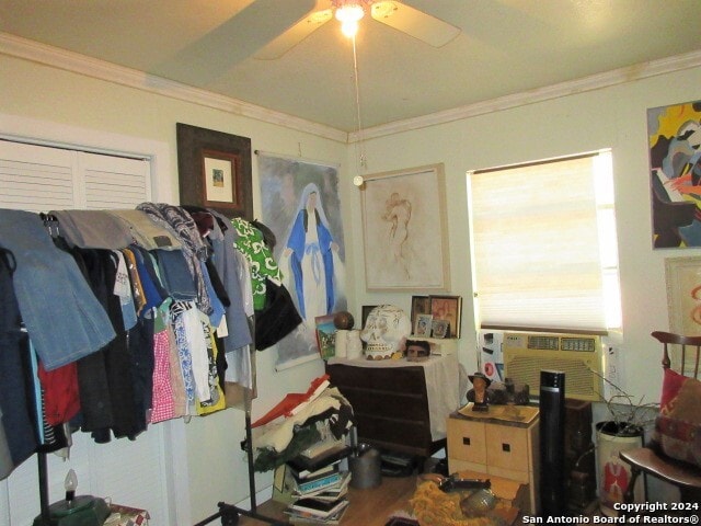 interior space with ceiling fan, cooling unit, and ornamental molding