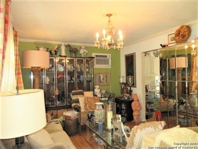 dining space featuring an inviting chandelier, hardwood / wood-style flooring, an AC wall unit, and crown molding