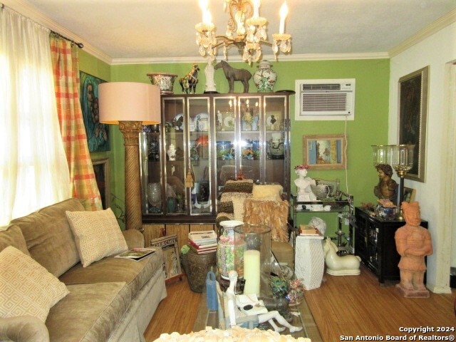 dining room featuring a wall mounted AC, crown molding, hardwood / wood-style floors, and an inviting chandelier