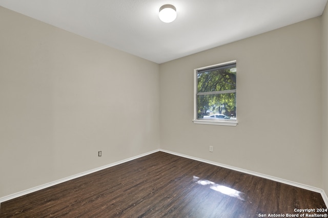 spare room with dark hardwood / wood-style floors