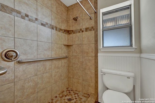 bathroom with tiled shower and toilet