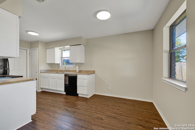 kitchen with white cabinets, black dishwasher, dark wood-type flooring, and sink