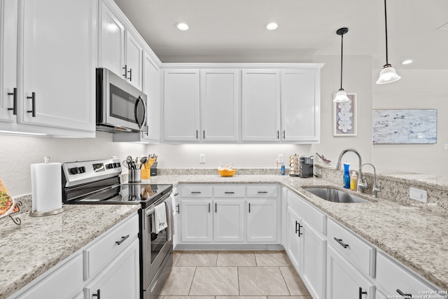 kitchen featuring stainless steel appliances, sink, and white cabinetry