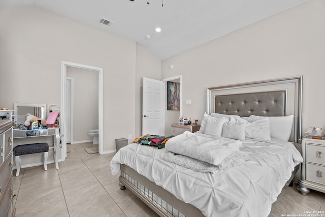 tiled bedroom featuring connected bathroom and high vaulted ceiling