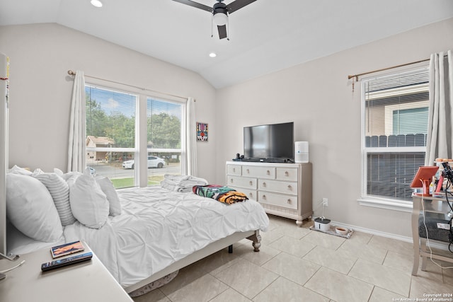 tiled bedroom with ceiling fan and lofted ceiling