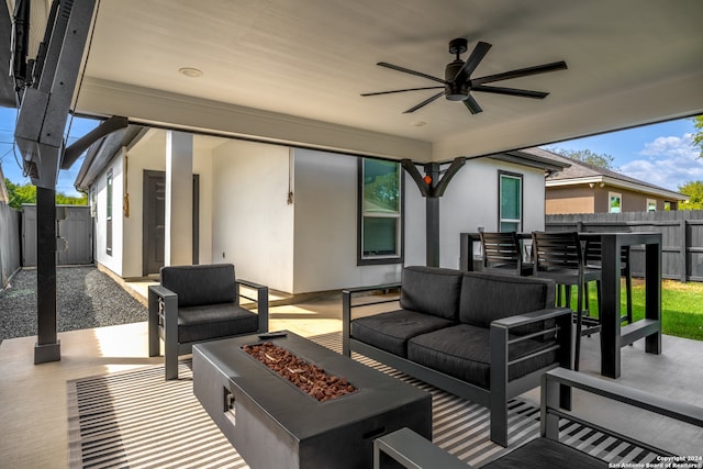 view of patio featuring an outdoor living space with a fire pit and ceiling fan