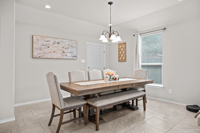 tiled dining space with a notable chandelier