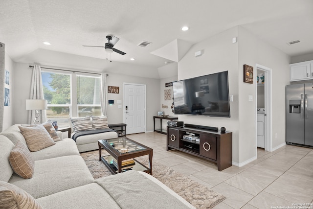 living room featuring a textured ceiling, lofted ceiling, washer / clothes dryer, and ceiling fan