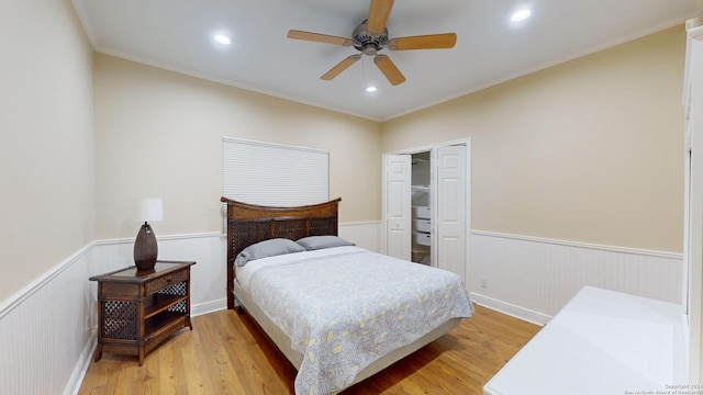 bedroom with ceiling fan, light hardwood / wood-style flooring, and crown molding