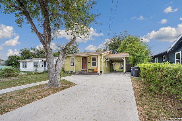 bungalow with a front lawn and a carport