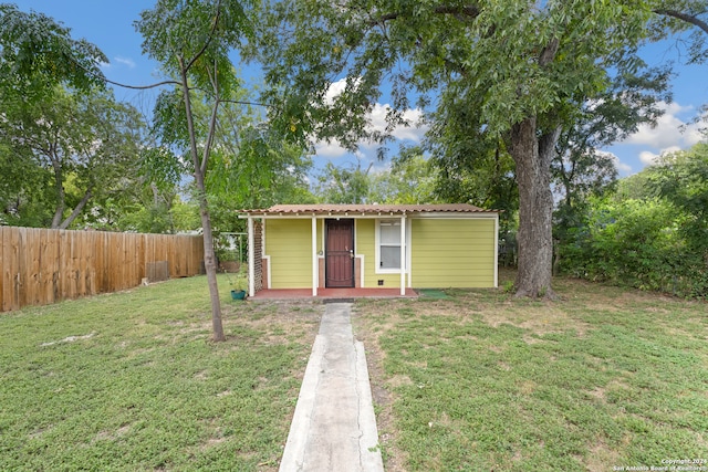 view of front of property with a front lawn and an outdoor structure