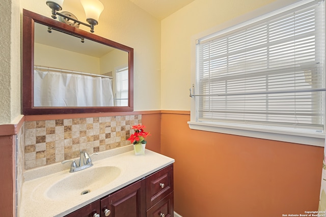 bathroom with decorative backsplash, vanity, and a shower with curtain