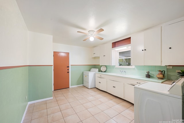 kitchen featuring ceiling fan, light tile patterned floors, washer and dryer, and white cabinetry