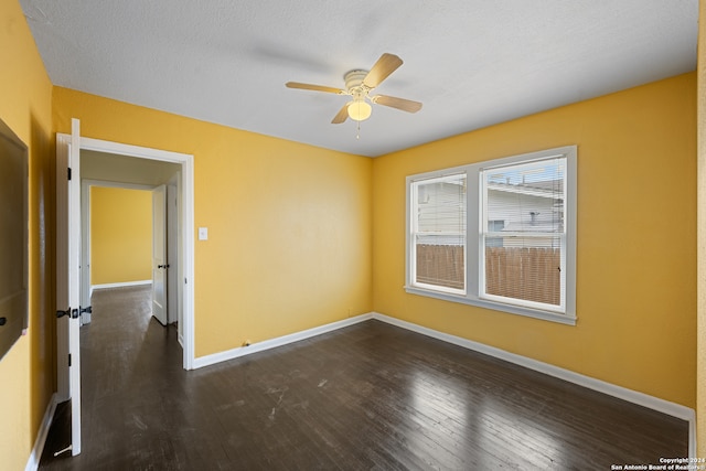 unfurnished room with a textured ceiling, dark hardwood / wood-style flooring, and ceiling fan