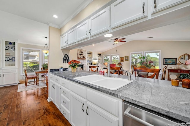 kitchen with sink, dark wood-type flooring, white cabinetry, dishwasher, and crown molding