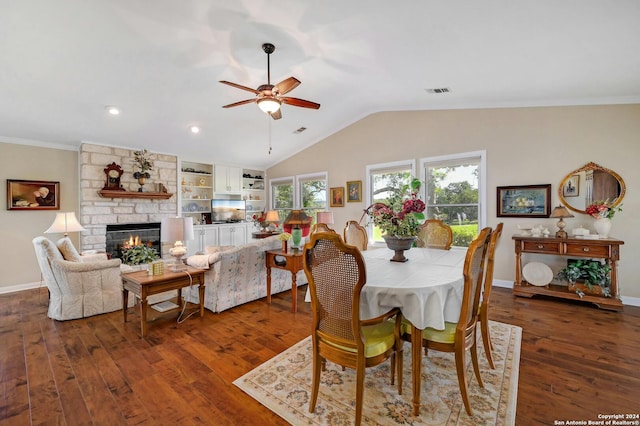 dining space featuring ornamental molding, ceiling fan, dark hardwood / wood-style floors, and a fireplace