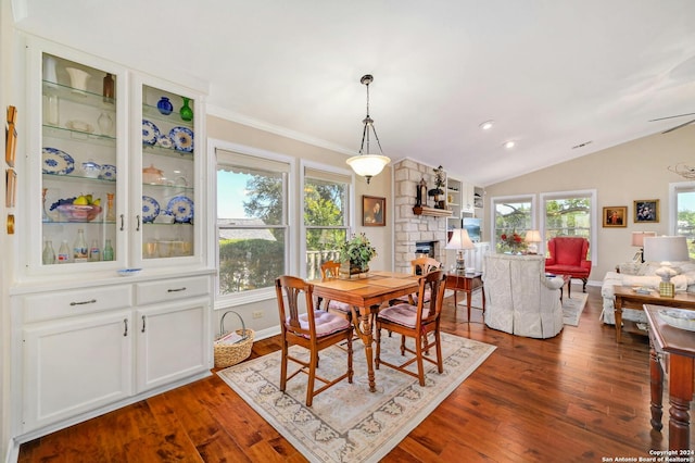 dining area with a wealth of natural light, lofted ceiling, and dark wood-type flooring