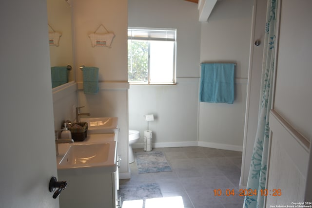 bathroom featuring tile patterned flooring, vanity, and toilet