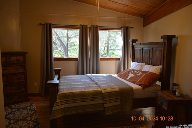 bedroom with dark wood-type flooring, vaulted ceiling, and wooden ceiling