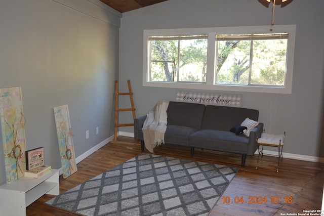 living room featuring lofted ceiling and hardwood / wood-style flooring