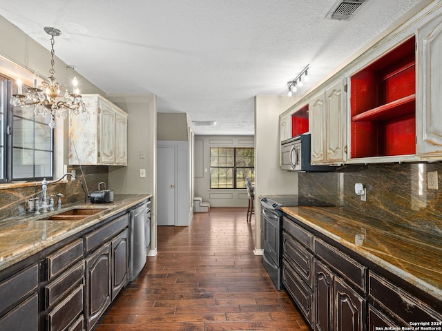 kitchen with stainless steel appliances, dark hardwood / wood-style floors, a chandelier, and tasteful backsplash