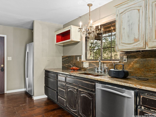 kitchen with appliances with stainless steel finishes, decorative backsplash, cream cabinets, and dark hardwood / wood-style floors