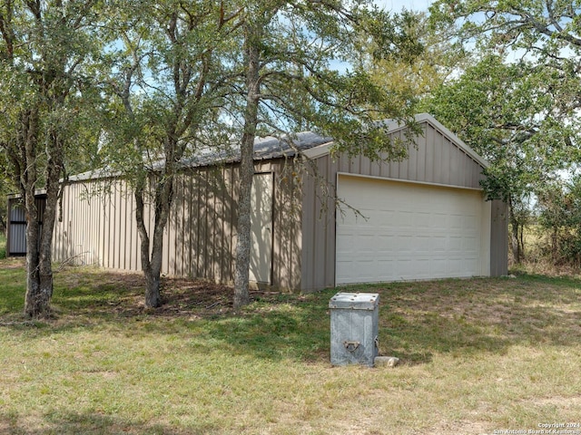 garage featuring a lawn