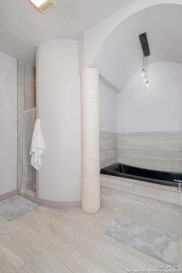 bathroom featuring tile patterned floors and a washtub