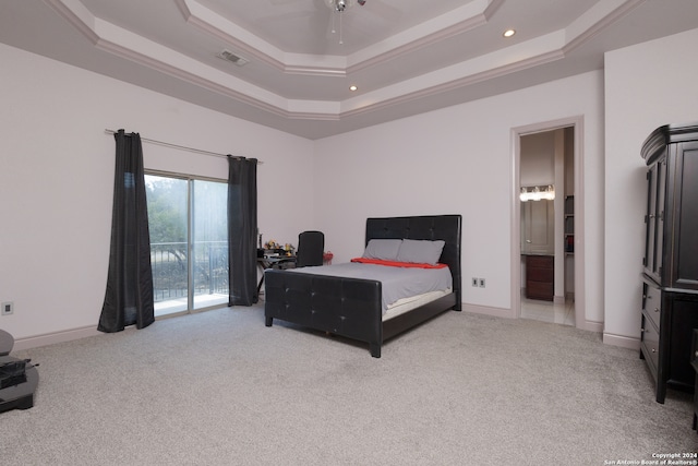 carpeted bedroom featuring ensuite bath, a raised ceiling, access to exterior, ceiling fan, and ornamental molding