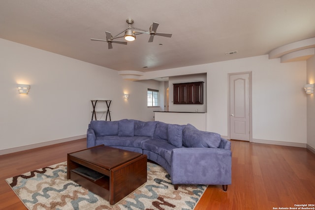 living room with ceiling fan and light wood-type flooring