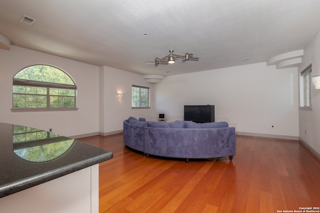 living room featuring ceiling fan and hardwood / wood-style flooring